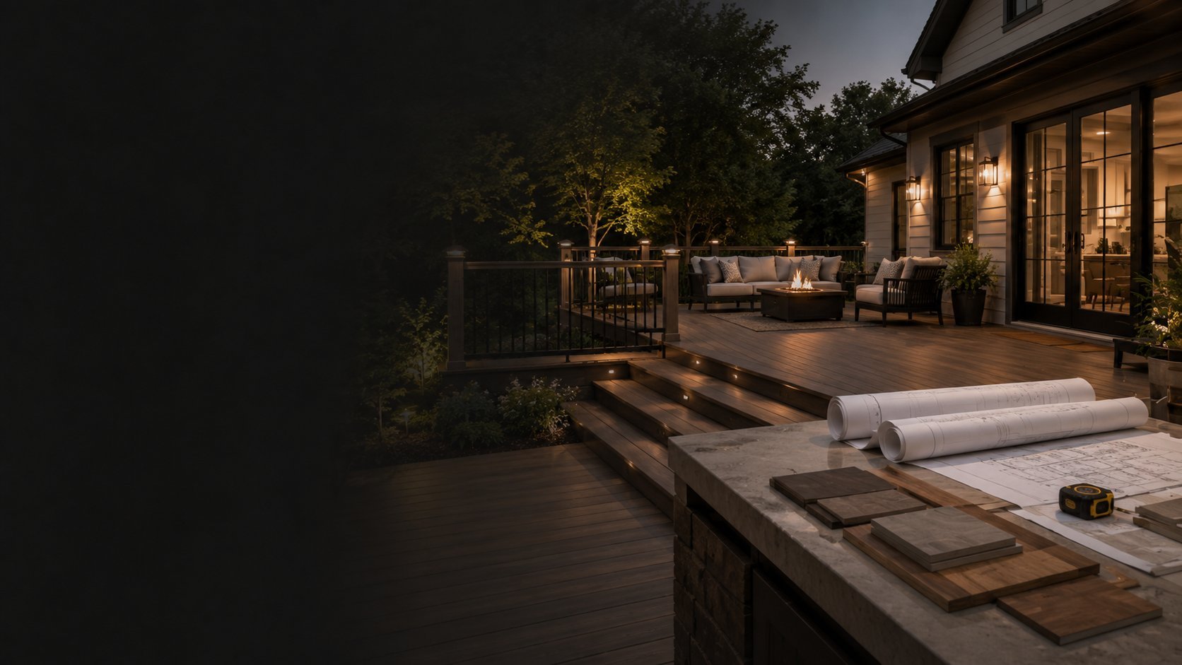 Evening view of modern home patio with lit deck, seating area, and architectural plans on table during twilight